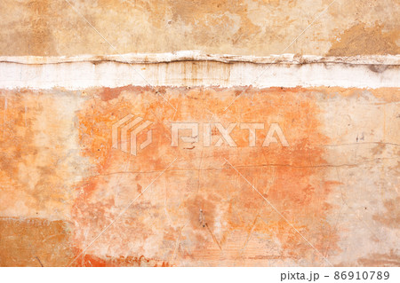 Texture of an old clay wall with cracks and scratches and an interfloor seam. 86910789