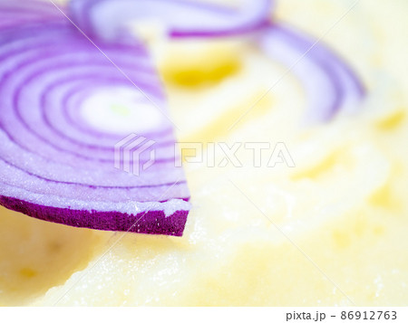 Selective focus on red onion slices in mashed potatoes. Selective focus on red onion slices in mashed potatoes. 86912763