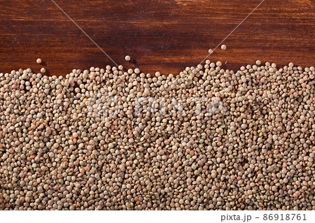Raw lentils on a wooden surface Raw lentils on a wooden surface 86918761
