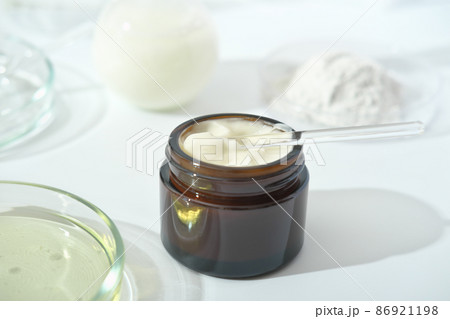 petri dishes with medium and glassware on a laboratory table. fermentation, fermented beauty skin care. container with cream or solution or serum for anti age treatment developed in a lab petri dishes with medium and glassware on a laboratory table. fermentation, fermented beauty skin care. container with cream or solution or serum for anti age treatment developed in a lab 86921198