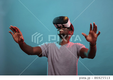 Cheerful adult looking up and enjoying vr goggles experience 86925513