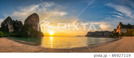 Tropical islands sunset view with ocean sea water and sand beach at Railay Beach, Krabi Thailand nature landscape panorama Tropical islands sunset view with ocean sea water and sand beach at Railay Beach, Krabi Thailand nature landscape panorama 86927119