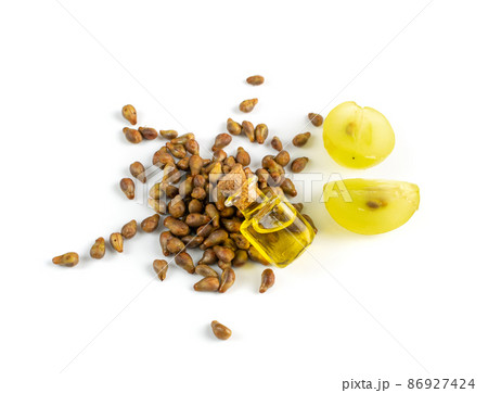 Grape Oil Seed in Small Vintage Bottle Isolated on White Background Grape Oil Seed in Small Vintage Bottle Isolated on White Background 86927424