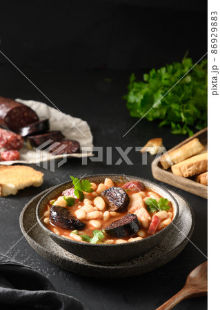 Spanish asturiana fabada on black table. Close up. 86929883