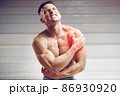 Injured shoulder. Young handsome muscular athlete having shoulder pain 86930920