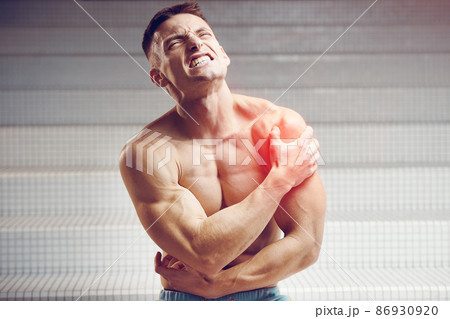 Injured shoulder. Young handsome muscular athlete having shoulder pain 86930920