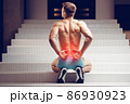 Injured spine. Young handsome muscular athlete having spine pain 86930923
