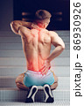 Injured spine. Young handsome muscular athlete having spine pain 86930926