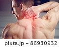 Injured neck. Young handsome muscular athlete having neck pain 86930932