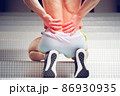 Injured spine. Young handsome muscular athlete having spine pain 86930935