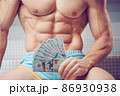 Cash dollars money in the hands of a muscular young man 86930938