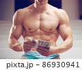 Cash dollars money in the hands of a muscular young man 86930941