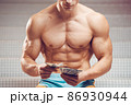 Cash dollars money in the hands of a muscular young man 86930944