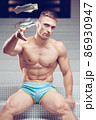 Muscular athletic generous man throws bills money, dollar 86930947