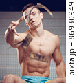 Muscular athletic generous man throws bills money, dollar 86930949