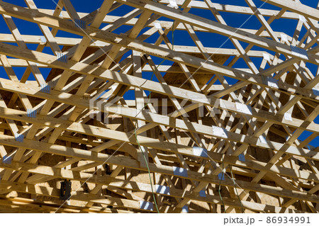 Roof trusses covered with condominium construction installation of wooden beams frame Roof trusses covered with condominium construction installation of wooden beams frame 86934991