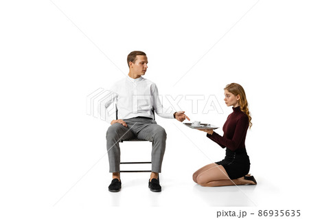 Infringement of rights, gender inequality. Two office workers in business suits in action isolated on white background. Infringement of rights, gender inequality. Two office workers in business suits in action isolated on white background. 86935635