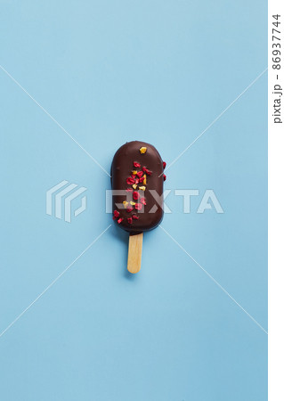 Mousse dessert with fruit flavors in the form of popsicle ice cream on blue background. Mousse dessert with fruit flavors in the form of popsicle ice cream on blue background. 86937744