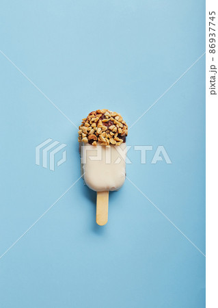 Mousse dessert with fruit flavors in the form of popsicle ice cream on blue background. Mousse dessert with fruit flavors in the form of popsicle ice cream on blue background. 86937745
