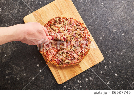 Fast food, Baked frozen pizza with ham, mushrooms and cheese on thick dough. Ready to eat. Fast food, Baked frozen pizza with ham, mushrooms and cheese on thick dough. Ready to eat. 86937749