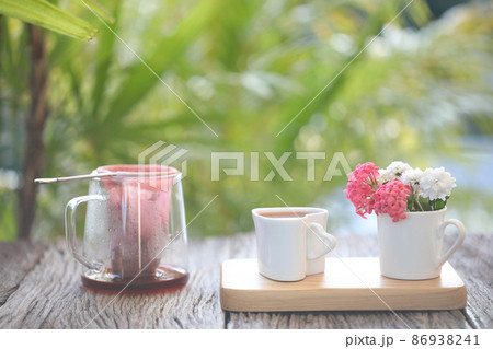 Rose tea and tea strainer filter pot and flowers on wooden tray Rose tea and tea strainer filter pot and flowers on wooden tray 86938241