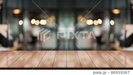 Empty wooden table top with lights bokeh on blur restaurant background.	 86939367