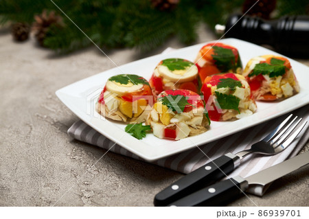 Portion of delicious chicken aspic on a plate isolated on concrete table Portion of delicious chicken aspic on a plate isolated on concrete table 86939701