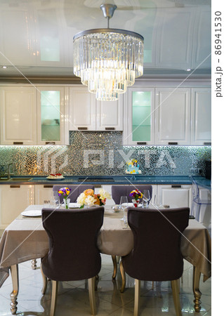 kitchen. served dining table with utensils and flowers in the dining room.  86941530