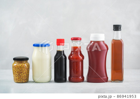 A set of different sauces on the table, gray background 86941953