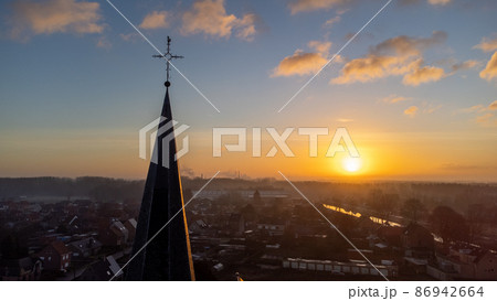 Cityscape silhouette of catholic church tower in Sint Jozef, Rijkevorsel, Belgium on a wonderful Cityscape silhouette of catholic church tower in Sint Jozef, Rijkevorsel, Belgium on a wonderful 86942664