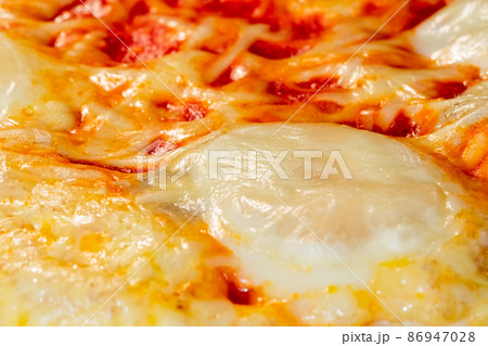 Baked homemade pizza Margherita in electric oven at home: close up Baked homemade pizza Margherita in electric oven at home: close up 86947028