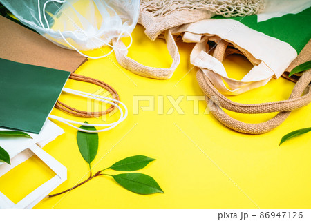 Eco Bags.Sustainable lifestyle.Zero waste, eco friendly shopping.Top view,flat lay.A variety of eco bags on a yellow background . Zero waste minimal composition with tring and canvas bags for storage. Eco Bags.Sustainable lifestyle.Zero waste, eco friendly shopping.Top view,flat lay.A variety of eco bags on a yellow background . Zero waste minimal composition with tring and canvas bags for storage. 86947126