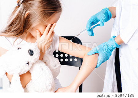 Vaccinations for children. The child was given a vaccine.Female doctor or nurse trying to give shot or vaccine against virus to a scared patient. Angry and distrustful patient refuses to receive it. Vaccinations for children. The child was given a vaccine.Female doctor or nurse trying to give shot or vaccine against virus to a scared patient. Angry and distrustful patient refuses to receive it. 86947139