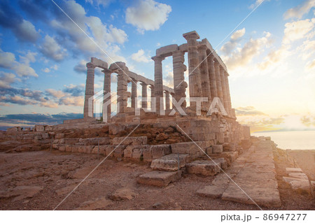 Greek temple ruins on sunset. Tourist landmark of Attica, Sounion, Greece Greek temple ruins on sunset. Tourist landmark of Attica, Sounion, Greece 86947277