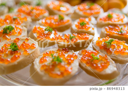 Plate with sandwiches with red caviar Plate with sandwiches with red caviar 86948313