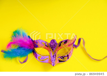 Carnival mask on yellow background. Mardi Gras concept. Fat Tuesday symbol. Copy space. Carnival mask on yellow background. Mardi Gras concept. Fat Tuesday symbol. Copy space. 86949945