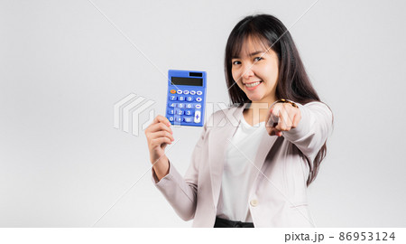 Woman confident smiling holding calculator and finger point to camera Woman confident smiling holding calculator and finger point to camera 86953124