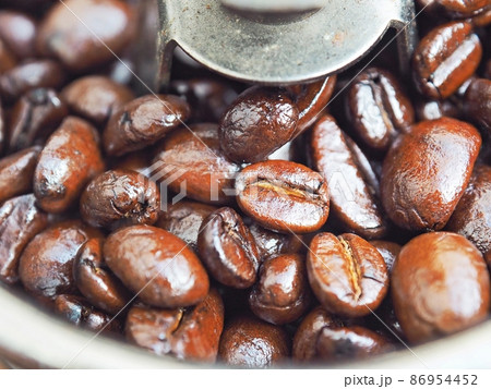 Close up Roasted Arabica coffee beans in grinder coffee machine. 86954452