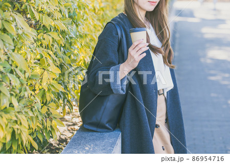 オフィス街でコーヒーを手に立っている女性 Office Lady オフィス街でコーヒーを手に立っている女性 Office Lady 86954716