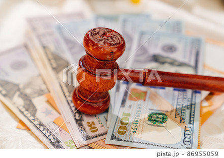 the judge's hammer on the banknotes. judicial corruption and justice. dollars the judge's hammer on the banknotes. judicial corruption and justice. dollars 86955059