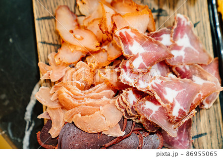 meat cuts on a wooden cutting board. dried delicacy meat.  86955065