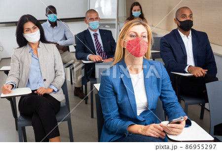 conference of international financial managers in mask in white room during quarantine conference of international financial managers in mask in white room during quarantine 86955297
