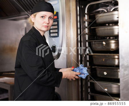Female cook near oven in restaurant kitchen 86955555