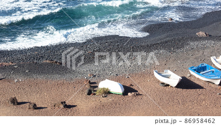 Green Lagoon at El Golfo with fishing boats on the beach, Lanzarote Green Lagoon at El Golfo with fishing boats on the beach, Lanzarote 86958462