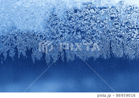 Beautiful ice pattern on window glass, winter texture Beautiful ice pattern on window glass, winter texture 86959016