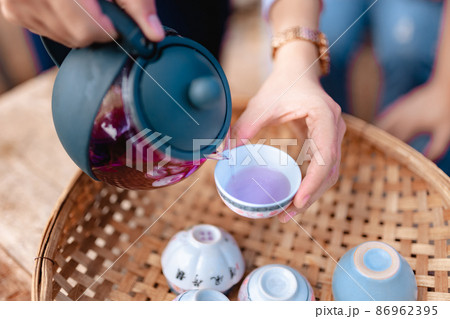 Teapot and tea cups on rattan at home 86962395