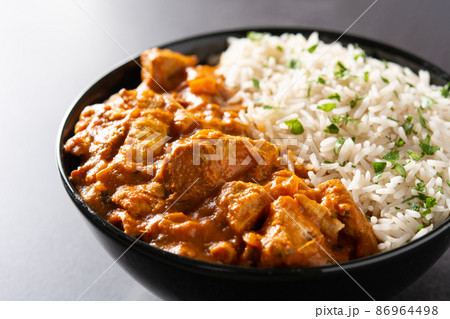 Indian butter chicken in black bowl 86964498