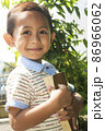 little boy smiling while hugging book looking at camera 86966062