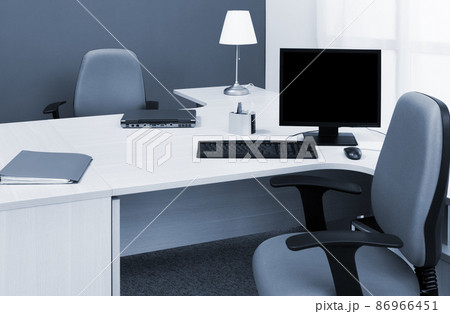 laptop and computer on desk in a modern office 86966451