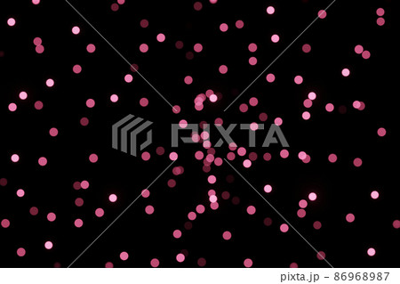 Defocused bokeh lights on black background, an abstract naturally blurred backdrop for Valentines Day or birthday party. Festive light texture. Violet blue garland in blur. Color 2022 86968987